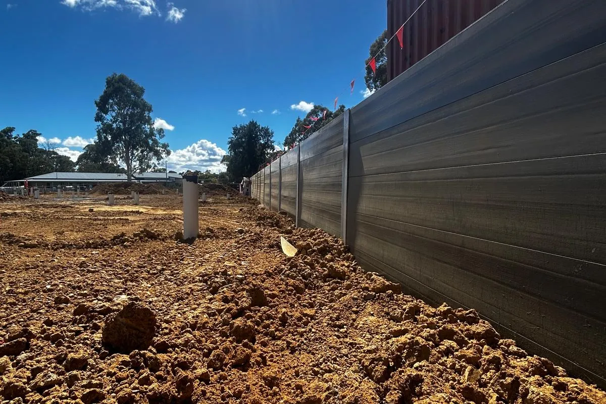 SuperSleeper wall construction across a cleared development site