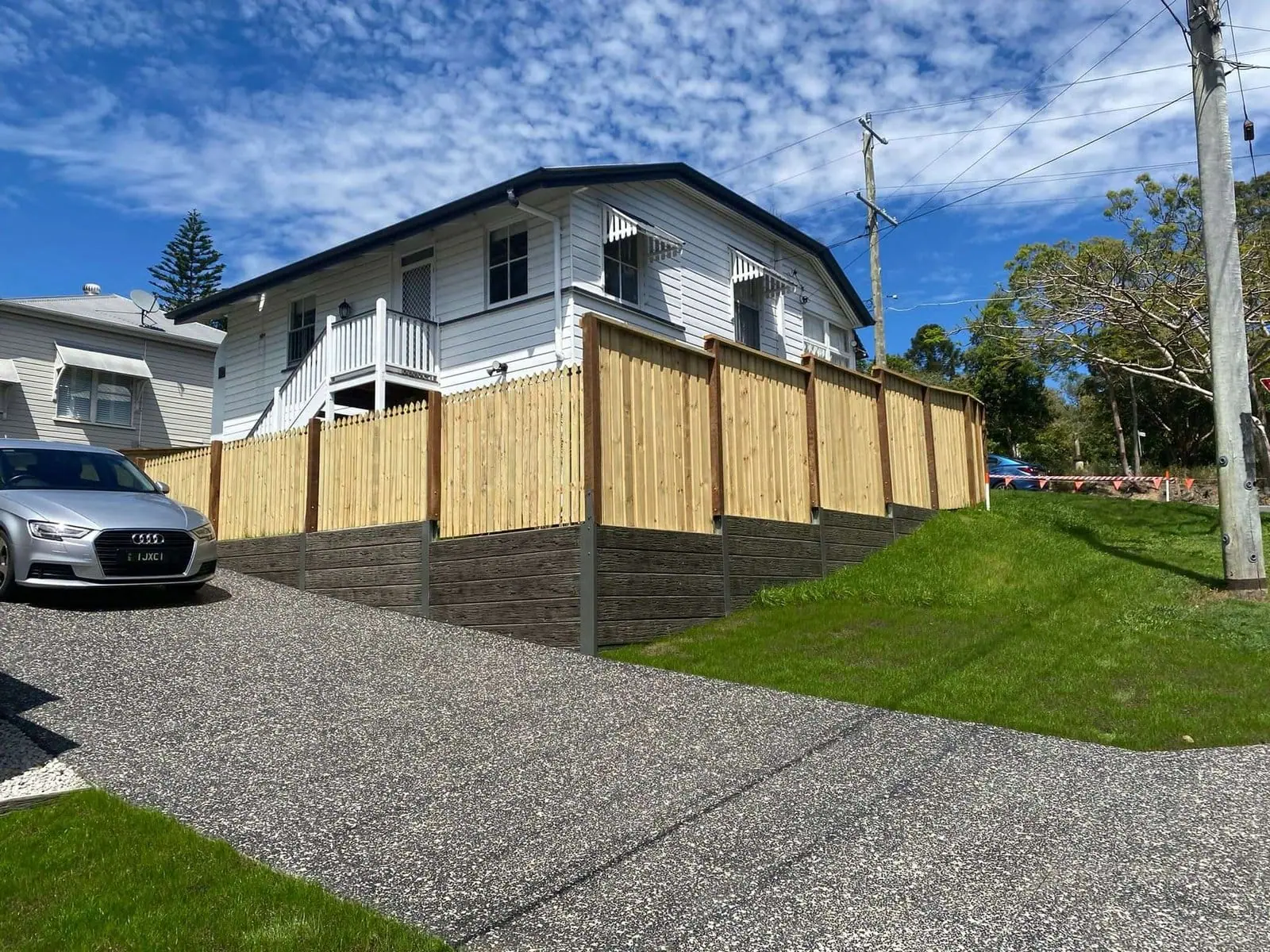 Residential timber fencing above a sleeper retaining wall
