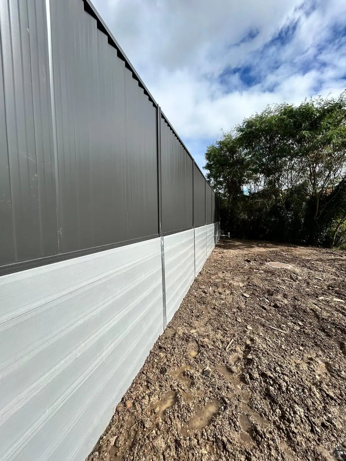 Two-tone concrete sleeper retaining wall at a residential property
