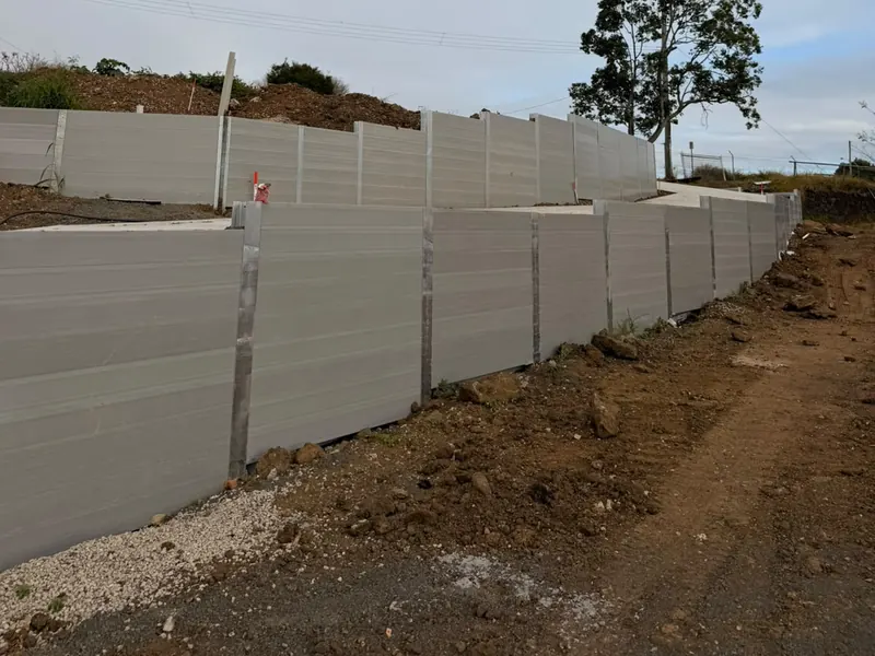 Tiered grey sleeper retaining walls with galvanised steel posts
