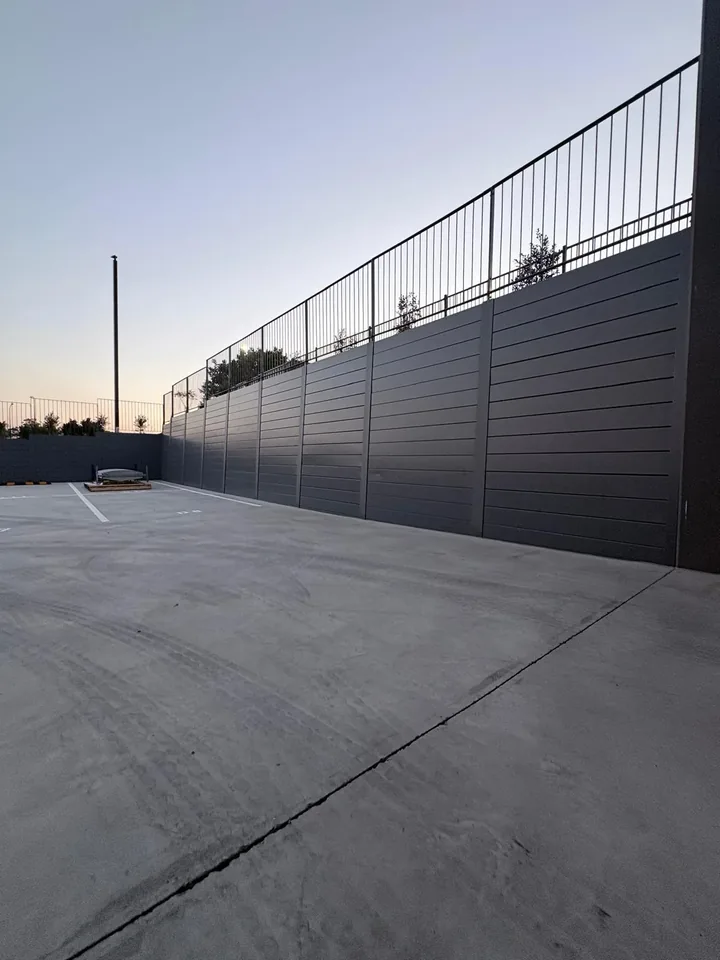 Black concrete sleeper retaining wall with balustrade at Rohrig's Augustine Heights project