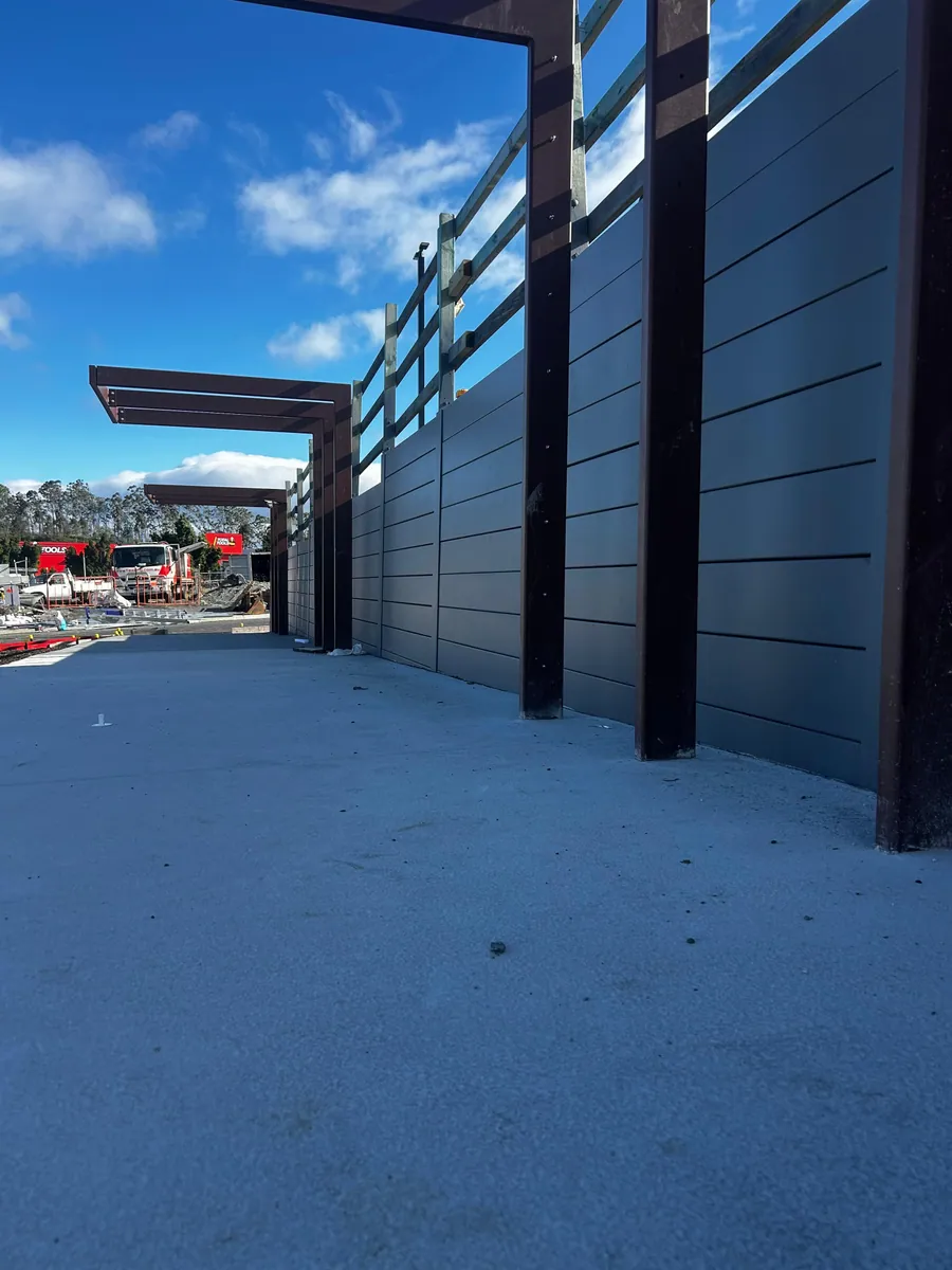 Commercial gateway framed by charcoal SuperSleeper walls