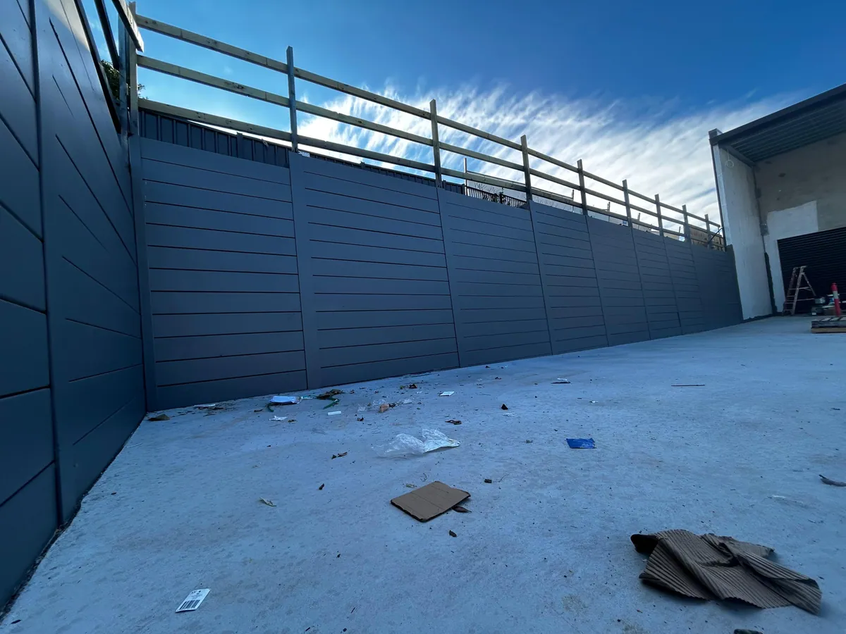 Wide view of a completed retaining wall in a commercial service yard