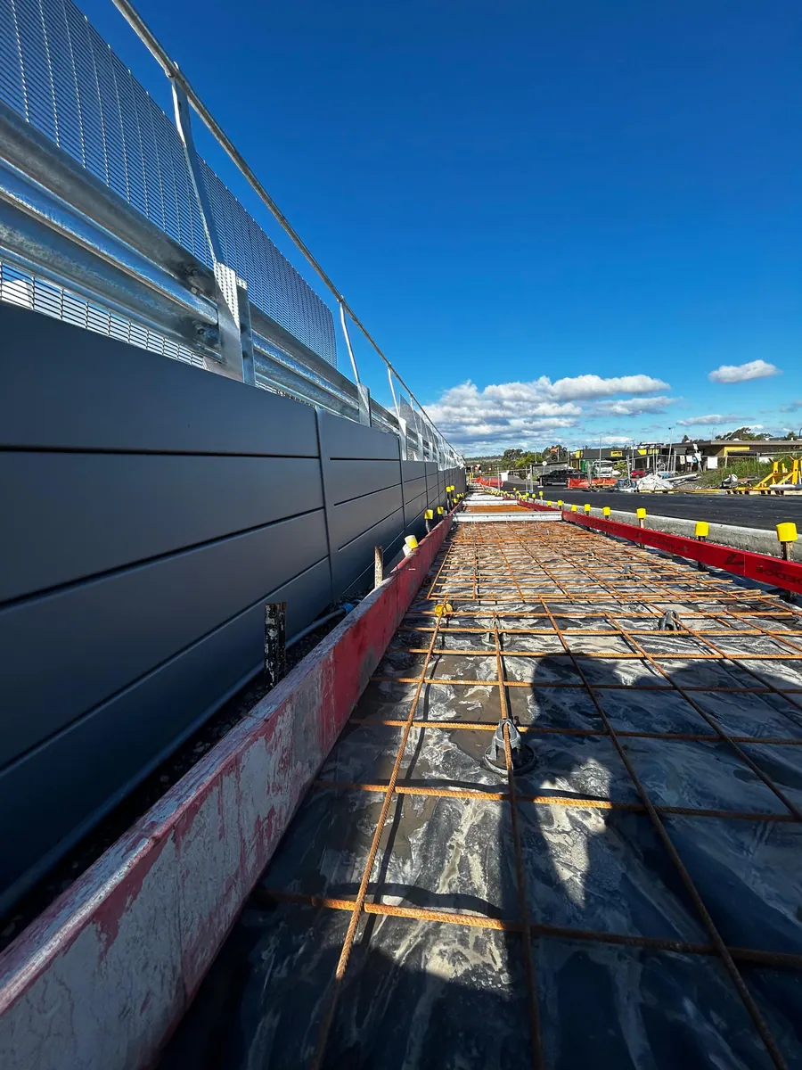 Commercial retaining wall beside reinforced concrete slab preparation