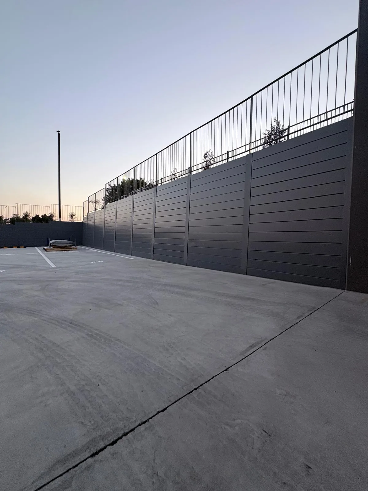 Completed commercial retaining wall with black safety balustrade