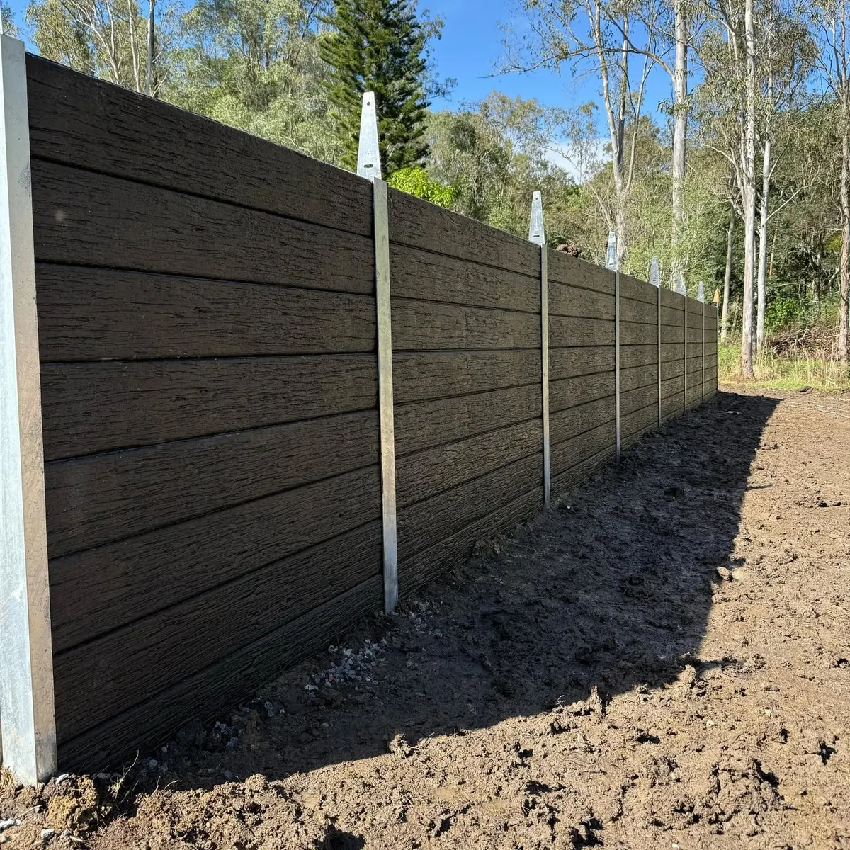 Timber-look concrete sleeper retaining wall in a residential yard