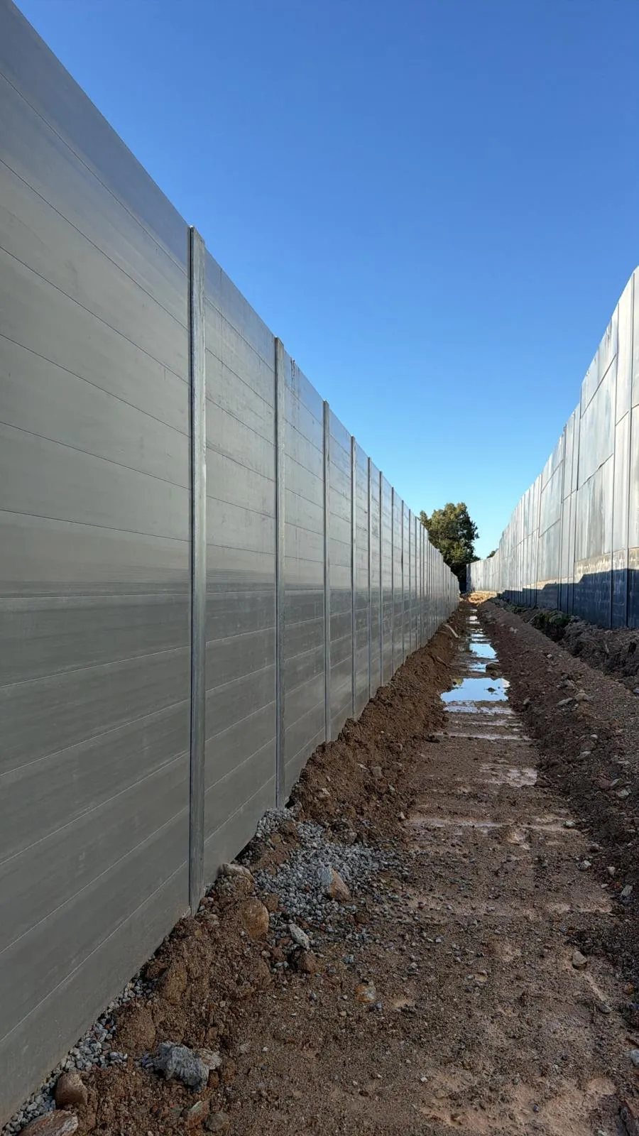 Long SuperSleeper wall beside a drainage trench